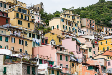 Fototapeta na wymiar Colourful houses on Italian hillside by the Mediteranian Sea