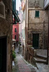 Fototapeta na wymiar Old Italian alley with shutterd windows