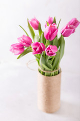 Pink tulips on a light background in handmade Vase. Pink tulip. Tulips. Flowers. Flower background. Flowers photo concept. Holidays photo concept. Copyspace
