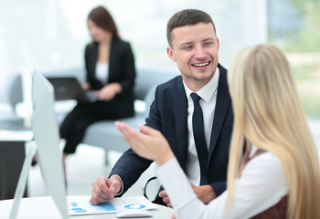 Fototapeta premium Image of two young business people interacting at meeting in off