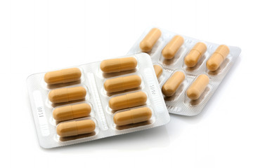 Packing of yellow tablets on a white background. Isolated