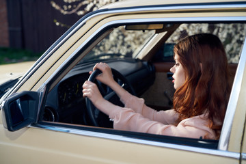 red-haired woman driving a car