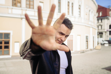 The man on the street looks at us through a hand. He as if not really wants that he was...