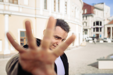 The man on the street looks at us through a hand. He as if not really wants that he was...