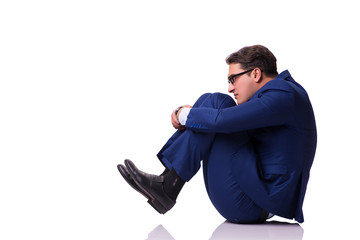 Businessman sitting on the floor isolated on white