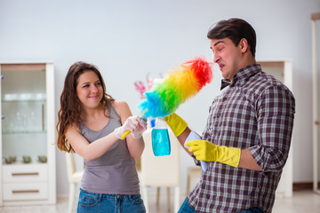 Wife and husband doing cleaning at home