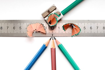 four pencil, sharpener, ruler and sliver on white isolated background