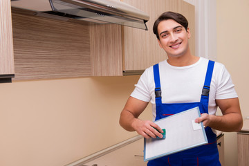 Young man working with kitchen equipment