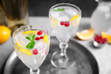 Refreshing cocktails with cranberry and lemon on table
