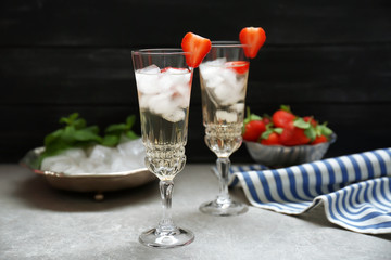 Refreshing cocktails with strawberry on gray table