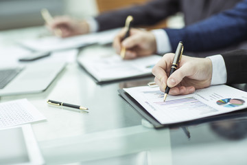 closeup of business team is working with the financial schedules in the workplace in the office