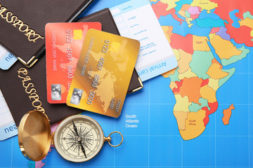 Credit cards with passports and tickets for vacations on world map background