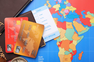 Credit cards with passports and ticket for vacations on world map background