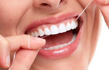 Fototapeta premium woman smile with tooth floss