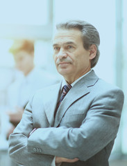 Smart business man aged with a team of friends, discussion in the background