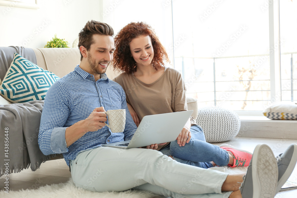 Canvas Prints Happy young couple with laptop at home