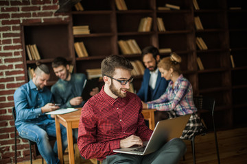 officer of the company with laptop on the background of business