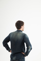 rear view of a stylish young man looking forward to the empty sp