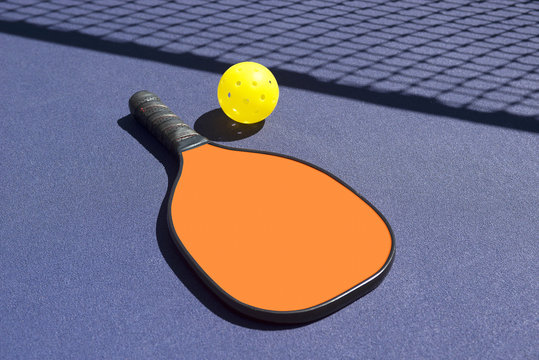 Pickleball Paddles and Ball(s) On Court