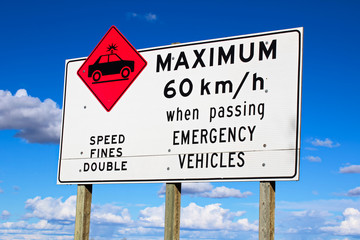 Maximum speed while passing emergency vehicles sign