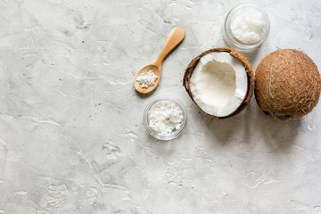 organic cosmetics with coconut on gray background top view
