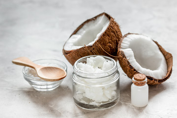 fresh coconut with cosmetic oil in jar on white background