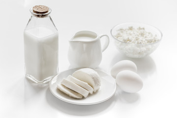 Healthy food concept with milk and cottage cheese on white table