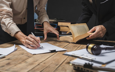 Teamwork of business lawyer meeting working hard about legal regislation in courtroom to help their...