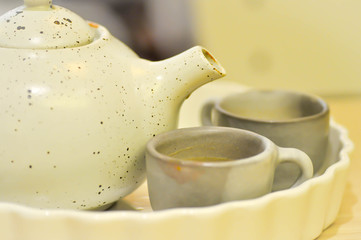 cup and tea pot on the table