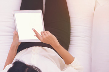 Close up Woman using tablet in coffee shop for summary of Business performance report or online marketting concept