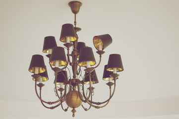 Chandelier on white ceiling in vintage style