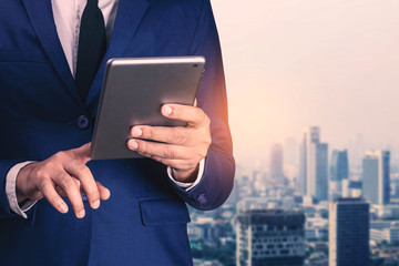 businessman with a tablet in city.