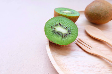 Fresh kiwi fruits on wooden background. Weight loss and detox concept. Top view and copy space