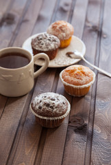 Cupcake with chocolate chips and a cup of tea