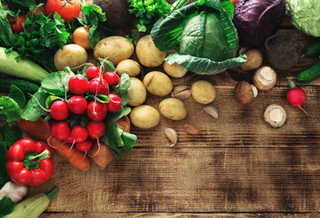 Set of fresh vegetables on wooden table with copy space