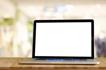 Laptop on wood table in cafe background. For graphics display montage.