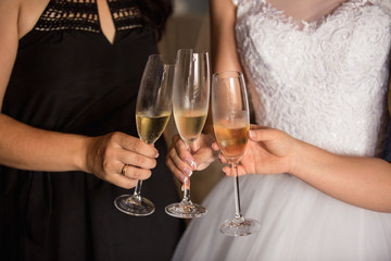 Bride and bridesmaids holding champagne glasses. Wedding party