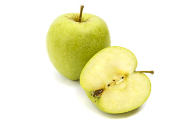 One whole and sliced green apple in droplets of dew isolated on white background