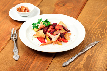 Plate of salad on a wooden table
