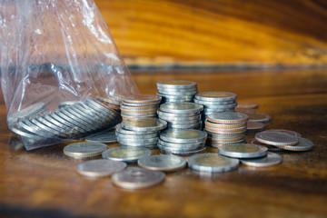 pile of money coins on wood background