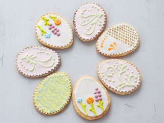 Easter treat. Homemade Easter shortbread cookies glazed with royal icing. Beautiful sugar cookies in the shape of eggs. Food background. Top view. Selective focus.