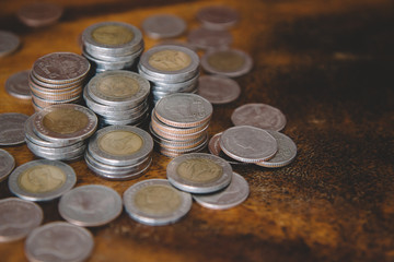 pile of money coins on wood background