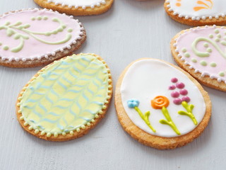 Easter egg shaped sugar cookies. Gingerbread glazed with royal icing. Food background. Macro image. Easter decoration or gift. Selective focus on the front.