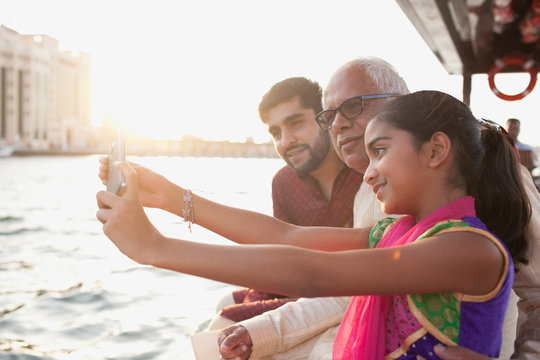 Girl talking selfie with family at Dubai Creek.