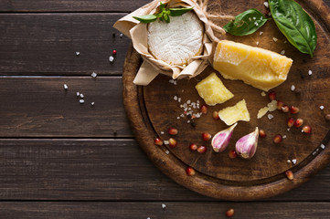 Cheese delikatessen closeup on rustic wood, brie and parmesan