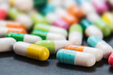 Different colors background of pills. Soft focus and shallow depth of field