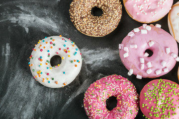 Donuts in a glaze assorted on a black background