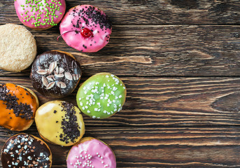 Glazed donuts with different fillings on a wooden table