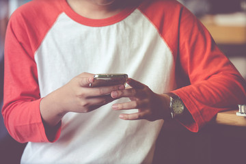 Man using smart phone in casual lifestyle, vintage tone background