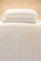 White pillows on comfortable bed  